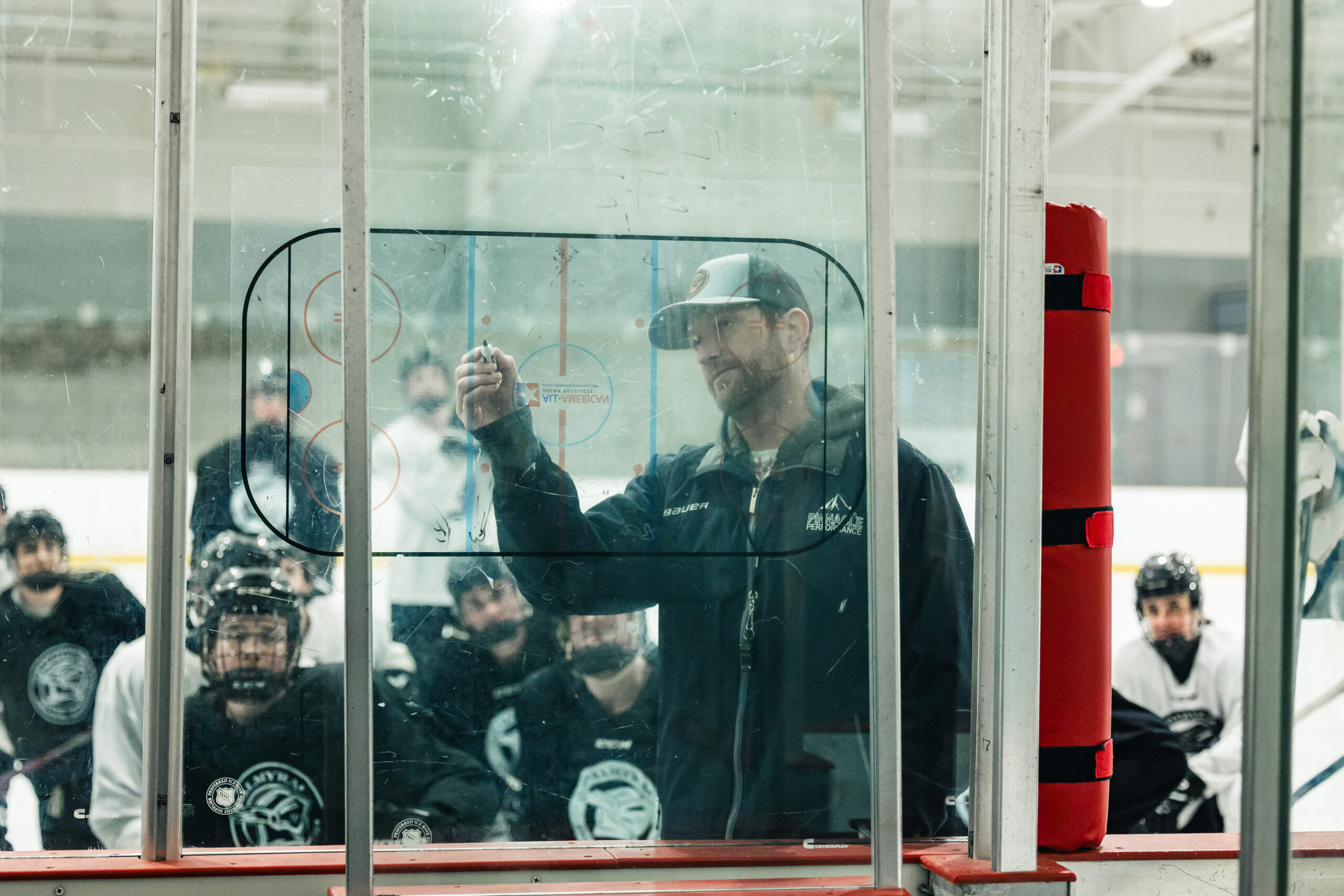 Youth athlete training coach watching through glass York Ice Arena