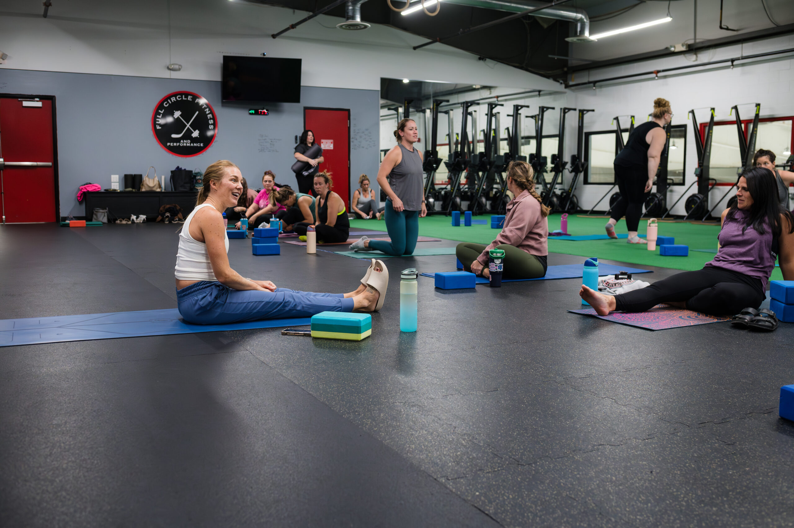 Members chatting and laughing after yoga class