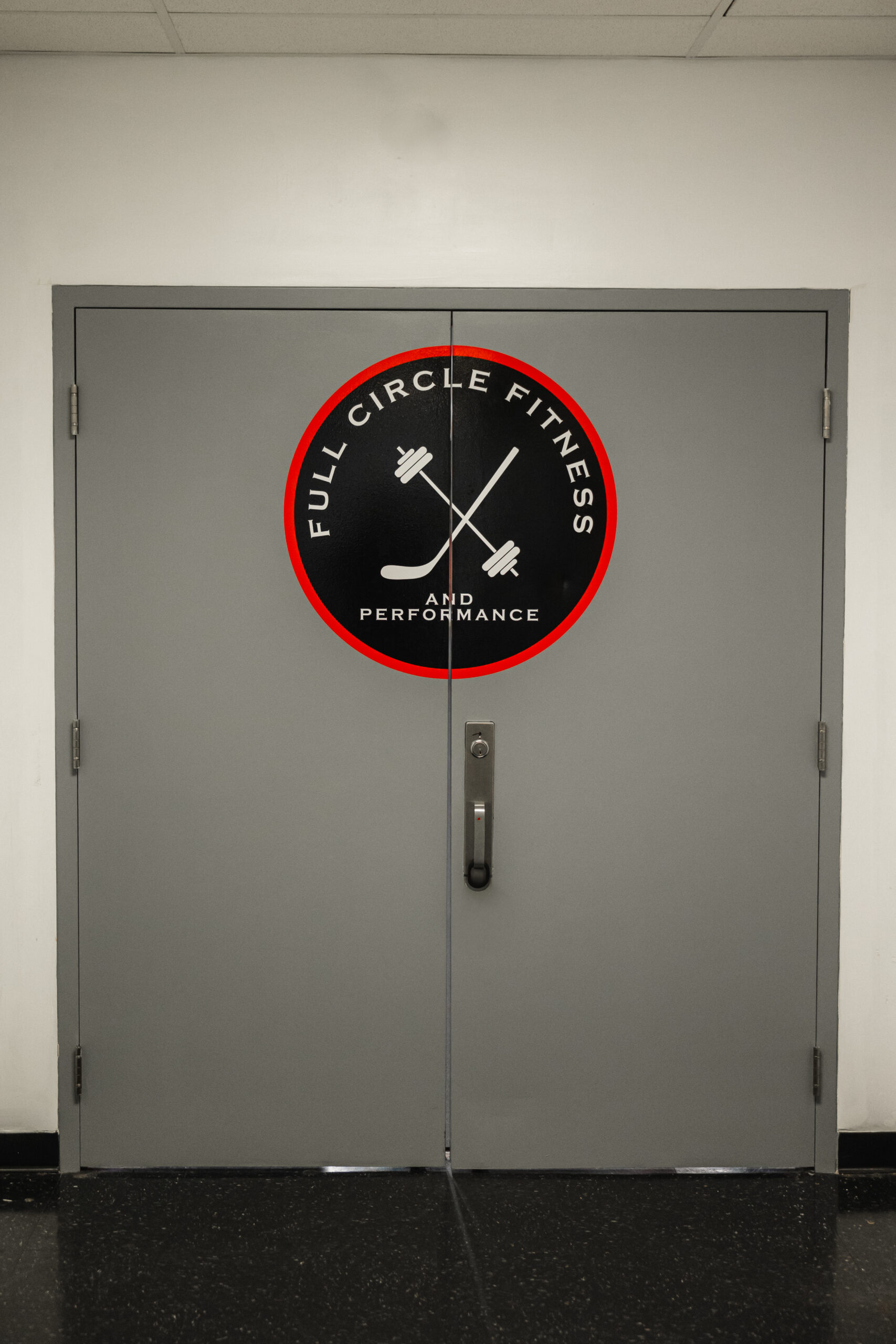 Full Circle Fitness logo door at end of hallway